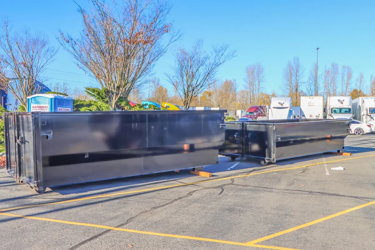 Professional dumpster rental service with roll-off container on residential driveway in Francisville